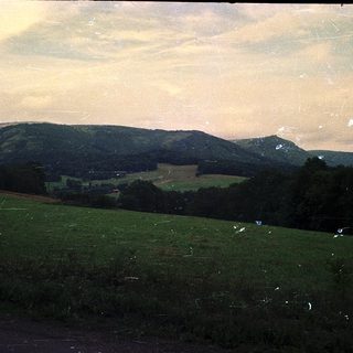 Rural landscape with rolling hills and open fields.