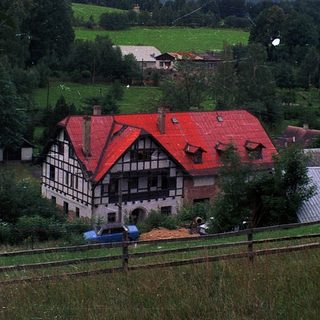 Rural alpine village with traditional timber house.