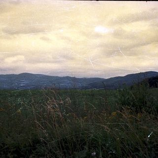 Rural landscape with rolling hills and open fields.