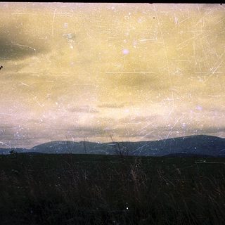 Frost-covered sky over distant mountains.