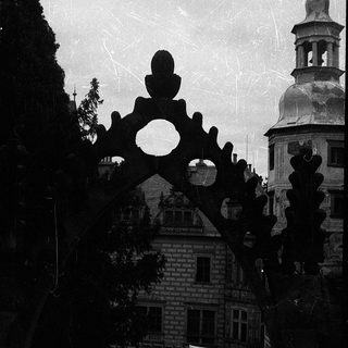 Historic building with ornate ironwork and dome.