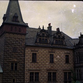 Historic brick building with steep gabled roofs.