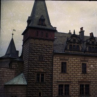 Historic brick building with steep gabled roofs.