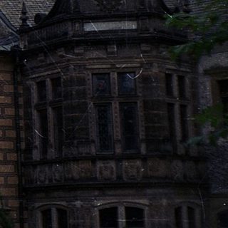 Historic brick building with steep gabled roofs.