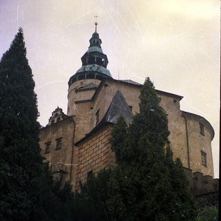 Medieval castle with tower and stone walls.