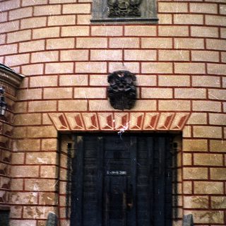 Historic stone building entrance with ornate door.