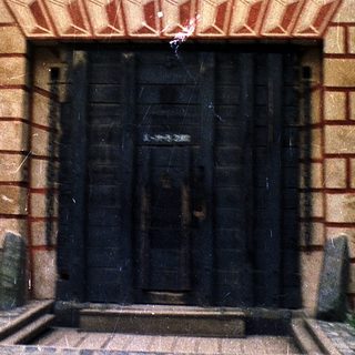 Historic stone building entrance with ornate door.