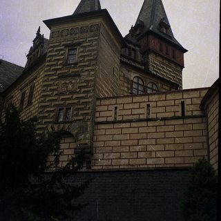 Historic castle with twin turrets and stone walls.