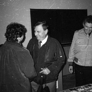 Group of people conversing indoors during an event.