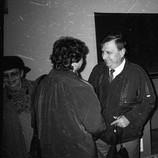 Group of people conversing indoors during an event.