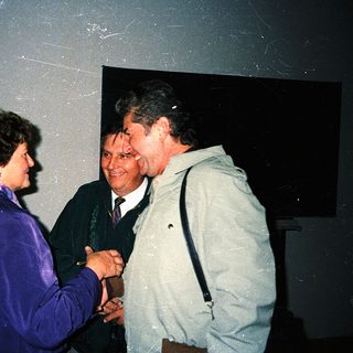 People shaking hands at an indoor event.