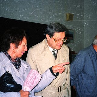 Group of older adults examining indoor display together.