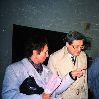 Group of older adults examining indoor display together.