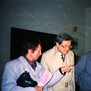 Group of older adults examining indoor display together.