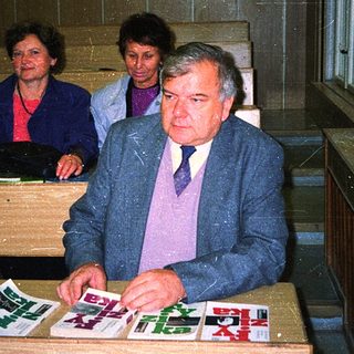 Men and women reviewing documents at a desk.