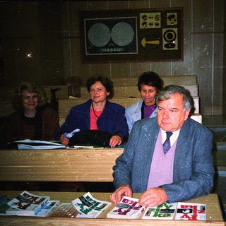 Men and women reviewing documents at a desk.