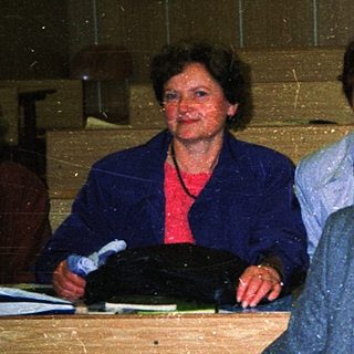 Men and women reviewing documents at a desk.