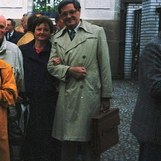 Group of people posing outside a building.