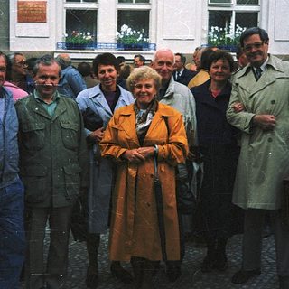 Group of people posing outside a building.