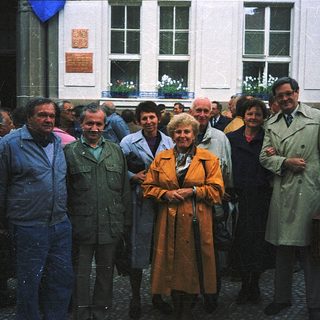Group of people posing outside a building.