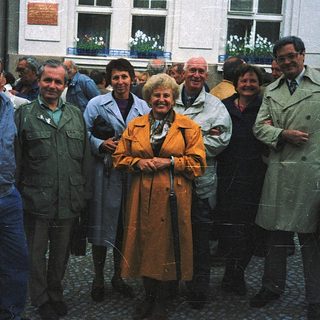 Group of people posing outdoors in 1970s-style clothing.