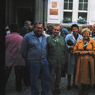 Group of people posing outdoors in 1970s-style clothing.