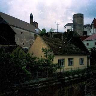 Historic European town with aged buildings.