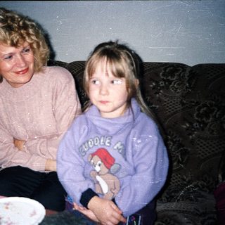 Two generations sitting together indoors.