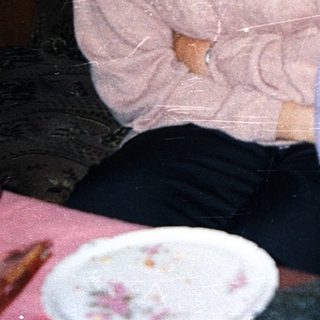 Two generations sitting together indoors.