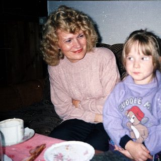 Two generations sitting together indoors.