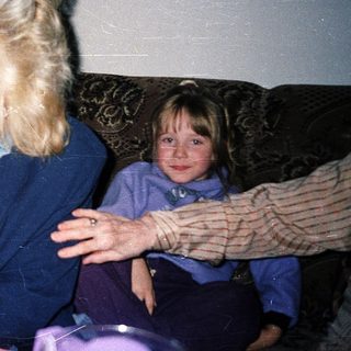Three people sitting indoors, likely having a casual conversation.
