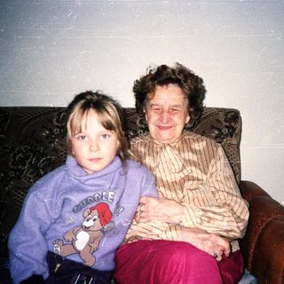 Two generations sitting together indoors.