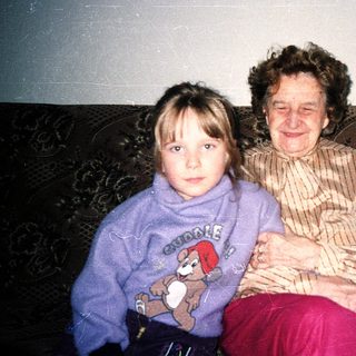 Two generations sitting together indoors.