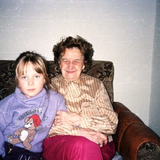 Two generations sitting together indoors.