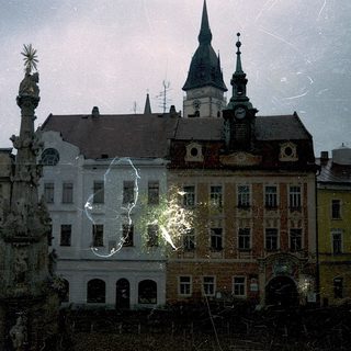 Historic European cityscape with ornate buildings and fountain.