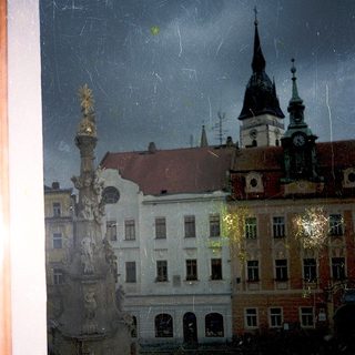 Historic European cityscape with column and spires.