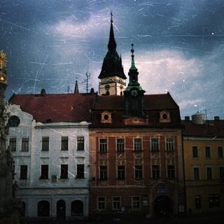Historic European cityscape at night with church spires.