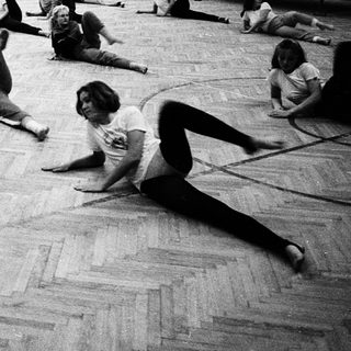 Group fitness or yoga class in gymnasium.