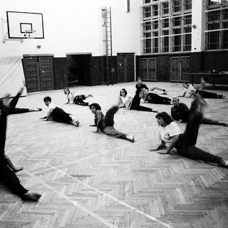 Group exercise or dance class in gymnasium.