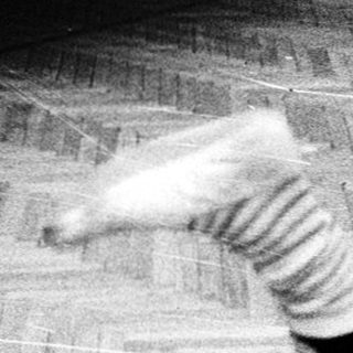 Person performing a dance move on wooden floor.