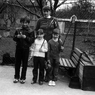 Family group photo outdoors in winter clothing.