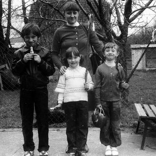 Family posing outdoors in winter clothing.