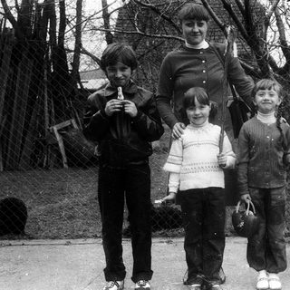 Family posing outdoors in winter clothing.