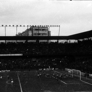 Historic soccer stadium filled with spectators.