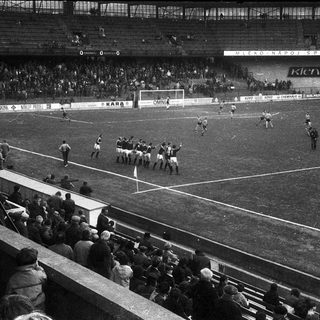 Black-and-white soccer match in stadium.