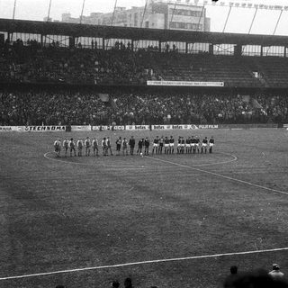 Pre-match team lineups on soccer field.