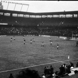 Black-and-white soccer match in stadium.