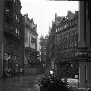 Historic European street with old architecture and rain.