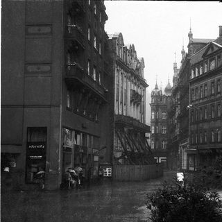 Historic European street with old architecture and rain.