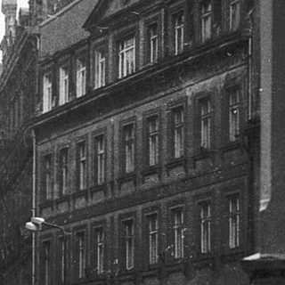 Historic European street with old architecture and rain.